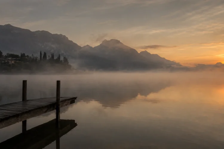 Lake at dawn · fog · still water